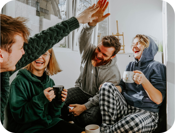 four people sitting around being happy enough to high five each other